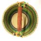 Top-down view inside the large round Bolga basket with fresh leafy tones and a band of deep inky checks, showing the coiled base and leather handle