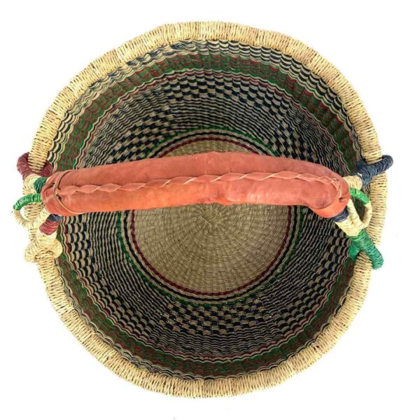 round-large-basket-866-bloom-red-green-black-woven-bolga-bashiri-2 Top-down view inside the large round Bolga basket with fine dark checks and rust and leafy stripes, showing the coiled base and leather handle