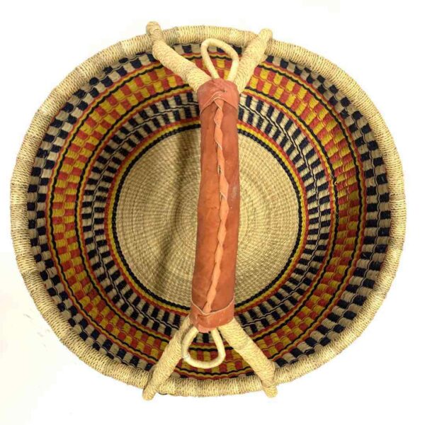 round-large-basket-867-joyful-orange-yellow-black-bolga-woven-bashiri-2 Top-down view inside the large round Bolga basket with sunny and fiery bands with dark zigzag rows, showing the coiled base and leather handle
