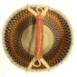 Top-down view inside the large round Bolga basket with sunny and fiery bands with dark zigzag rows, showing the coiled base and leather handle