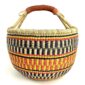 Front view of the large round Bolga basket with sunny and fiery bands with dark zigzag rows, on a white background