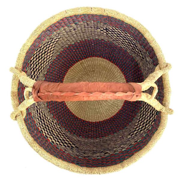 round-large-basket-868-glow-teal-red-navy-bolga-african-bashiri-2 Top-down view inside the large round Bolga basket with a sea-green and berry band over fine inky patterning, showing the coiled base and leather handle