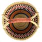 Top-down view inside the large round Bolga basket with warm burnt tones framing rosy and inky stripes, showing the coiled base and leather handle
