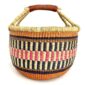 Front view of the large round Bolga basket with warm burnt tones framing rosy and inky stripes, on a white background