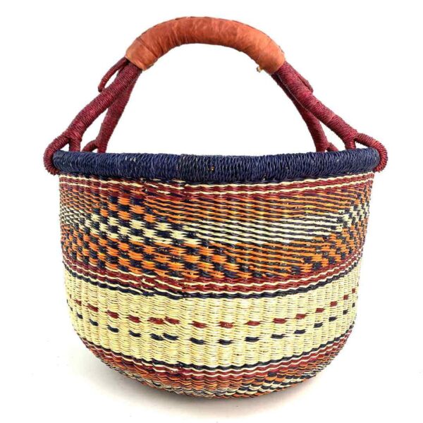 round-large-basket-870-abundance-navy-red-orange-bolga-woven-bashiri-3 Front view of the large round Bolga basket with an inky rim over rust and amber patterning, on a white background