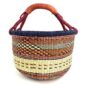 Front view of the large round Bolga basket with an inky rim over rust and amber patterning, on a white background