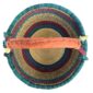 Top-down view inside the large round Bolga basket with deep sea-green bands and berry stripes, showing the coiled base and leather handle