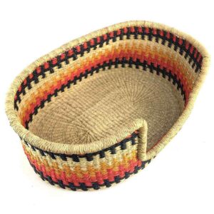Angled view of the small red and orange pet basket showing the woven elephant grass base