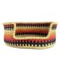 Front view of the small red, orange and black zigzag Bolga pet basket with its dipped front