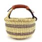 Front view of the small round Bolga basket with deep-toned stripes on a natural weave