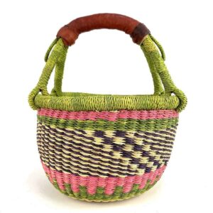 Front view of the small round Bolga basket with a chequered body and bright handle wraps