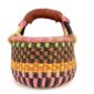 Front view of the small round Bolga basket with bold chequered bands in warm tones