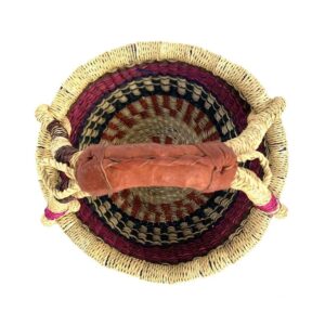 small-round-basket-715-crystal-pink-navy-bolga-woven-bashiri-2 Top-down view inside the small round Bolga basket with pink and navy bands on natural straw, showing the coiled base