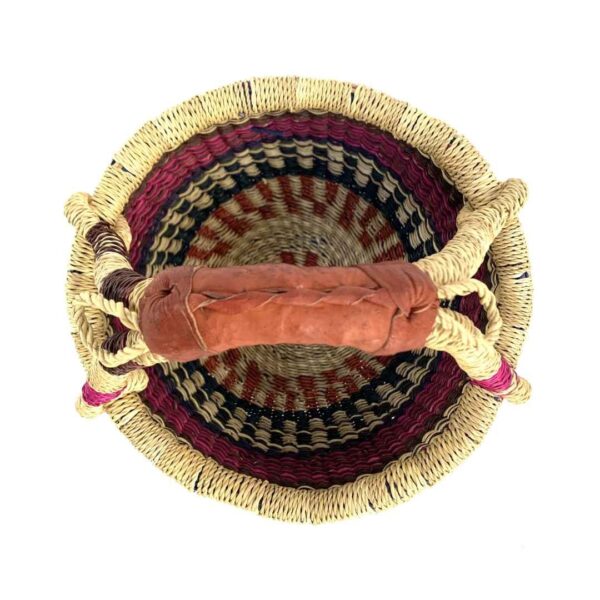 small-round-basket-715-crystal-pink-navy-bolga-woven-bashiri-2 Top-down view inside the small round Bolga basket with pink and navy bands on natural straw, showing the coiled base