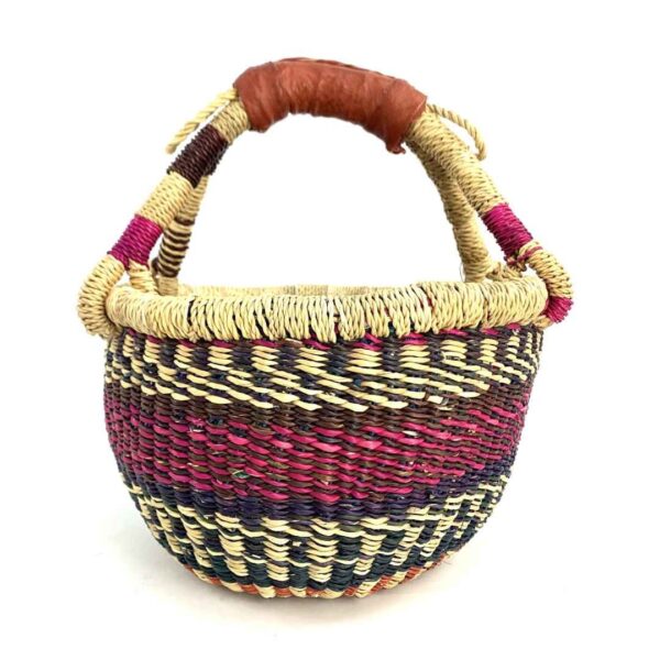 small-round-basket-715-crystal-pink-navy-bolga-woven-bashiri-3 Front view of the small round Bolga basket with pink and navy bands on natural straw, on a white background