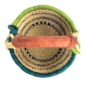 Top-down view inside the small round Bolga basket with navy stripes on natural straw with a teal and green rim, showing the coiled base