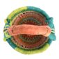 Top-down view inside the small round Bolga basket with green rim and coral, orange and dark bands, showing the coiled base