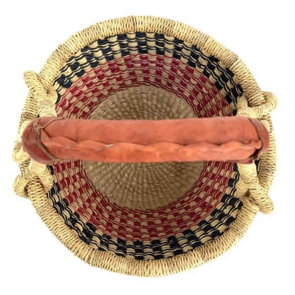 small-round-basket-726-solution-navy-red-bolga-woven-bashiri-2 Top-down view inside the small round Bolga basket with navy checks over red and pink bands, showing the coiled base