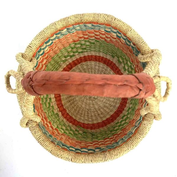 small-round-basket-727-atoms-orange-green-bolga-african-basket-bashiri-2 Top-down view inside the small round Bolga basket with orange and green zigzag bands, showing the coiled base