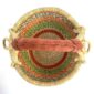 Top-down view inside the small round Bolga basket with orange and green zigzag bands, showing the coiled base