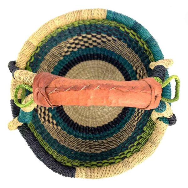 small-round-basket-730-clay-lime-teal-bolga-woven-bashiri-2 Top-down view inside the small round Bolga basket with lime, teal and navy bands, showing the coiled base