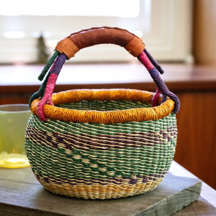 small african basket, woven in ghan, in natural and green oclours