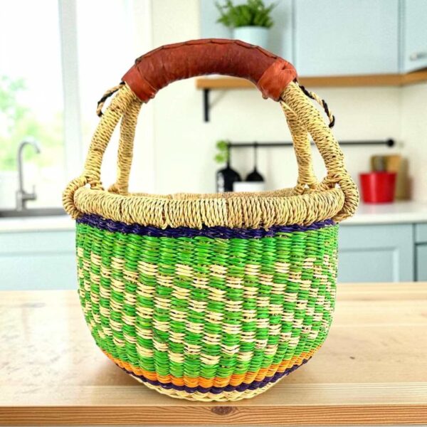 small-round-bolga-basket-709-afia-bashiri Small round Bolga basket with a chequered body in fresh, bright tones and leather-wrapped handle