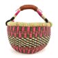 Front view of the small round Bolga basket with a checked pattern in warm, deep tones