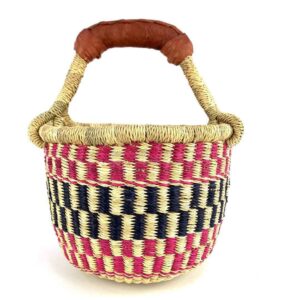 Front view of the small round Bolga basket with a bold chequered pattern in bright and dark tones