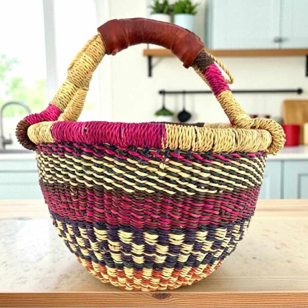 small-round-woven-basket-708-yaw-bashiri Small round Bolga basket with bands and checked detail in deep, warm tones and leather-wrapped handle