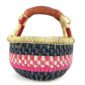 Front view of the small round Bolga basket with a bright chequered band framed in deep tones