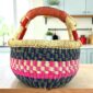 Small round Bolga basket with a bright chequered band framed in deep tones and leather-wrapped handle