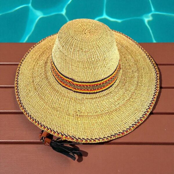 Handwoven African hat featuring natural grass and vibrant colours.