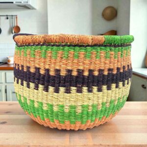 Round Bolga storage basket with lime green, coral and navy bands and no handles