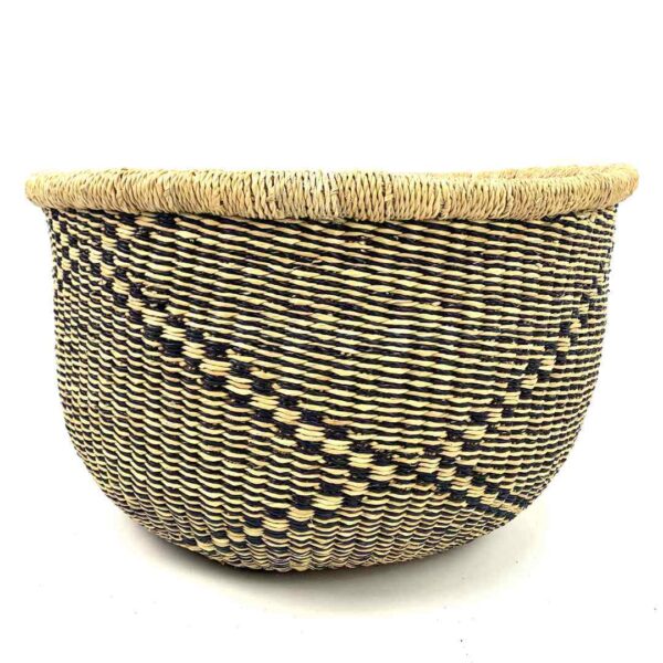 uba-basket-280-andor-black-natural-round-storage-bolga-woven-bashiri-3 Front view of the round Bolga storage basket with a black and natural diagonal pattern and no handles on a white background