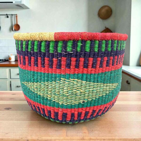Round Bolga storage basket with teal, red, navy and green bands with a pale diamond band, and no handles