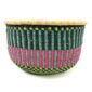Front view of the round Bolga storage basket with teal, navy and pink stripes and no handles on a white background