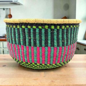 Round Bolga storage basket with teal, navy and pink stripes and no handles