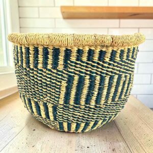 Round Bolga basket with no handles in navy and natural, handwoven from elephant grass