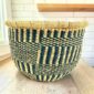 Round Bolga basket with no handles in navy and natural, handwoven from elephant grass