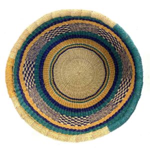 Top-down view inside the teal and yellow round Bolga basket, showing the coiled base