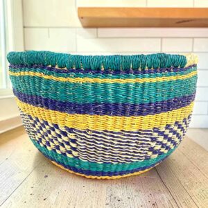 Round Bolga basket with no handles in teal and yellow, handwoven from elephant grass