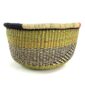 Front view of the olive and black round Bolga basket on a white background