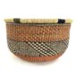 Front view of the rust and black round Bolga basket on a white background