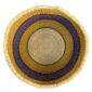 Top-down view inside the yellow and purple round Bolga basket, showing the coiled base