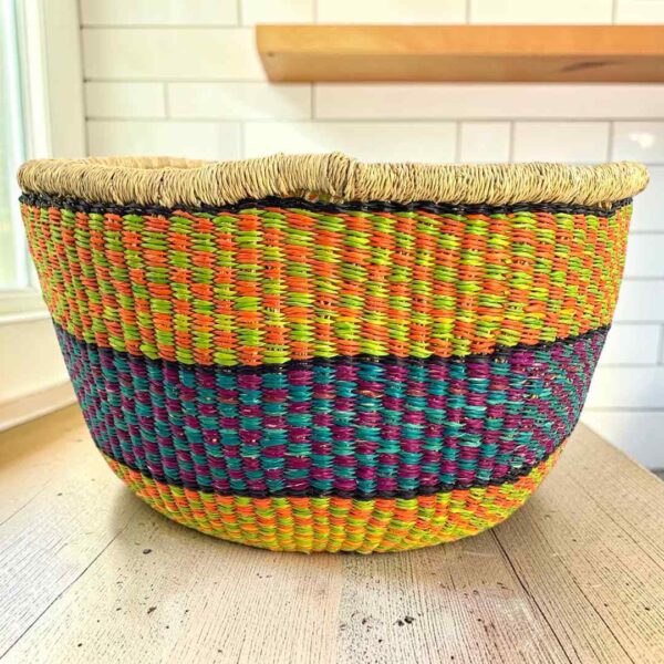 Round Bolga basket with no handles in yellow and purple, handwoven from elephant grass