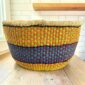 Round Bolga basket with no handles in yellow and purple, handwoven from elephant grass