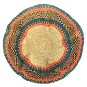 Top-down view inside the teal and orange bolga wave basket, showing the coiled base