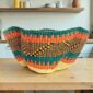 Bolga wave basket in teal and orange, handwoven from elephant grass