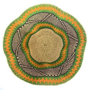 Top-down view inside the green and orange bolga wave basket, showing the coiled base